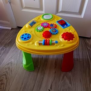 Mostly baby toys and items and a glass table.